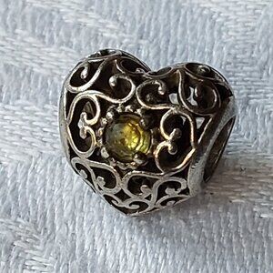 Authentic Pandora sterling open work heart charm with green crystal
